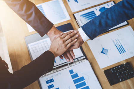 Image of business people joining and putting hands together during their meeting, connection and...