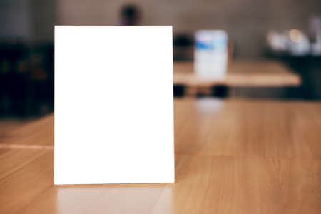 Mock up blank menu frame on table in coffee shop stand for your text of display your product.の写真素材