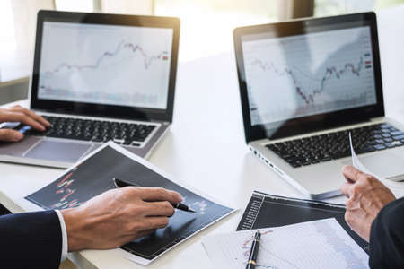 Business team investment working with computer and analysis graph stock market trading with stock...
