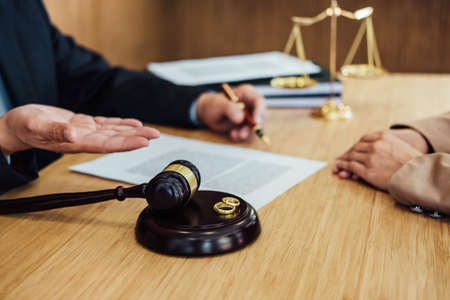 Marriage divorce on Judge gavel deciding, Consultation between a Businesswoman and Male lawyer or...