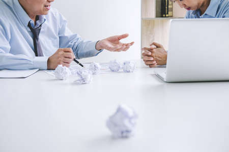 Boss and executive team feeling stress and serious of fail business, Team dispute of failure and exhausted with problems with a pile of work, sadness by bad news.の写真素材