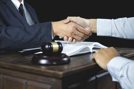 Congratulation and collaboration concept, Shaking hands after good cooperation, Businessman handshake with male lawyer after discussing good deal of contract in courtroom.の写真素材