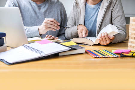 Education, teaching, learning, technology and people concept. Two high school students or classmates...
