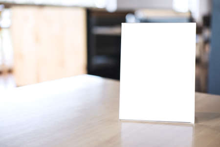 Mock up blank menu frame on table in coffee shop stand for your text of display your product.の写真素材