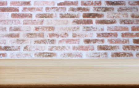 Selected focus empty wooden table and wall texture or old brick wall blur background image. for your photomontage or product display.の写真素材