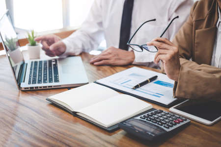 Business team working with new startup project plan and discussion information for financial strategy with laptop and digital tablet in a modern business lounge.の写真素材