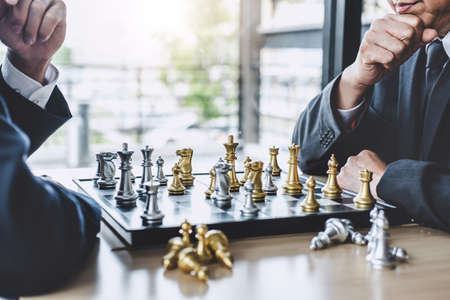 Two businessman playing chess game to plan strategy for success, thinking for planning overcoming...