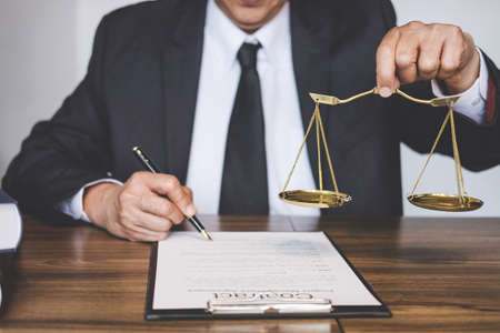 Judge gavel with Justice lawyers, Lawyer or counselor working on a documents and holding balance in...