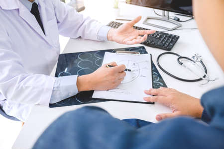 Professor doctor recommend report a method with patient treatment, results on examine a picture brain x-ray film about the problem of the patient while working in office.の写真素材