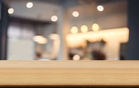 Selective Empty wooden table and blurred background of abstract in front of coffee shop or restaurant for display of product or for montage.の写真素材