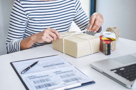 Small business owner delivery service and working packing box, business owner working checking order to confirm before sending customer in post office, Shipment Online Sales.の写真素材