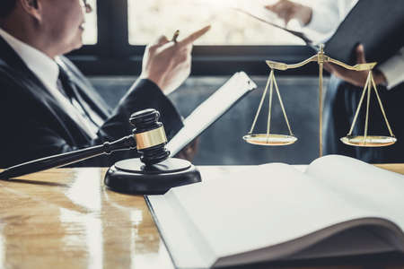 Male lawyer or Counselor working in courtroom have meeting with client are consultation with contract papers of real estate, Law and Legal services concept.の写真素材