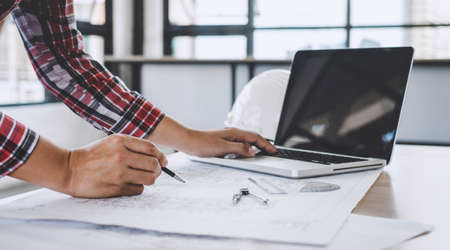 Construction concept, Hands of architect or engineer working for new project plan on blueprint,...