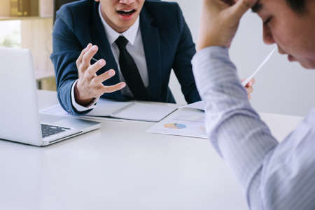Boss and executive team feeling stress and serious of fail business, Team dispute of failure holding heads in hands with problems with a pile of work, sadness by bad news.の写真素材
