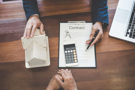 Real estate broker agent presenting and consult to customer to decision making sign insurance form...