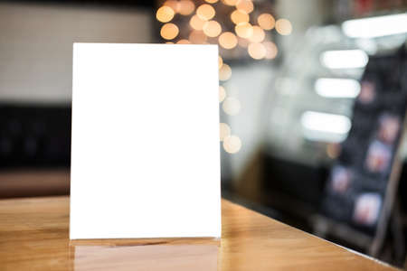 Mock up blank menu frame on table in coffee shop stand for your text of display your product.の写真素材