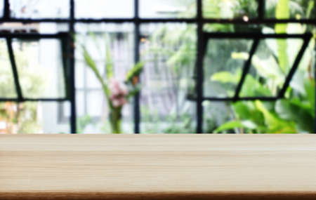 Empty wooden table and blurred background of abstract in front of coffee shop or restaurant for...
