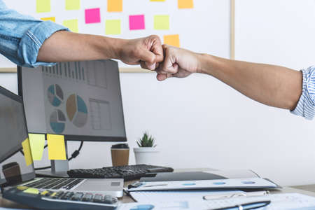Teamwork of businesspeople partnership giving fist bump to greeting start up business strategy...