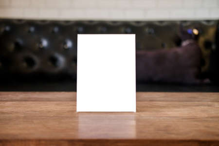 Mock up blank menu frame on table in coffee shop stand for your text of display your product.の写真素材