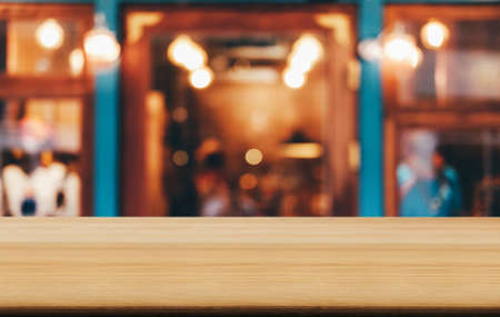 Selective Focus Empty wooden table in front of abstract blurred festive background with night market background bokeh for product montage display of product.の写真素材