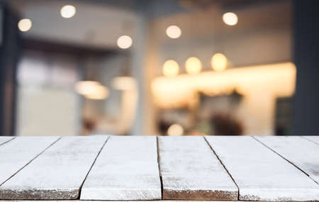 Selective Empty wooden table and blurred background of abstract in front of coffee shop or restaurant for display of product or for montage.の写真素材
