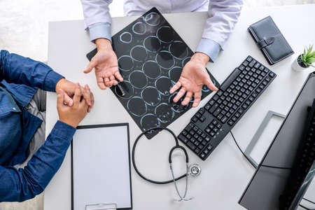 Professor doctor recommend report a method with patient treatment, results on examine a picture brain x-ray film about the problem of the patient while working in office.の写真素材