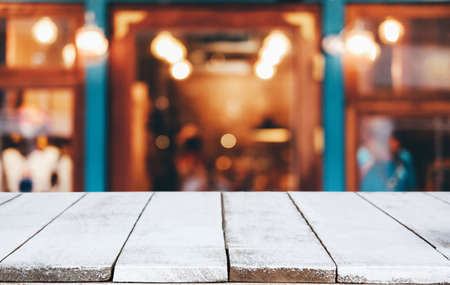 Selective Focus Empty wooden table in front of abstract blurred festive background with night market background bokeh for product montage display of product.の写真素材