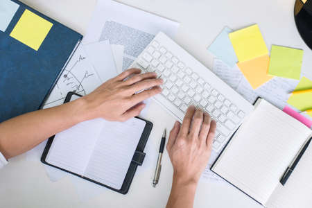 Businessman working writing making note business plan and graphic designer with computer in office.の写真素材