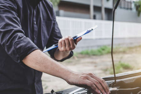 Services car engine machine concept, Automobile mechanic repairman checking a car engine with...