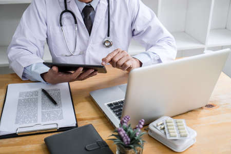 Health care and Medical concept, doctor checking patient history form while think about finding a...