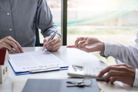 Real estate broker agent presenting and consult to customer to decision making sign insurance form...