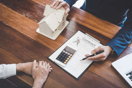 Real estate broker agent presenting and consult to customer to decision making sign insurance form...