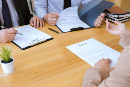 Business woman explaining about his profile to two selection committee manager sitting in during job Interview, interview the job and hiring.の写真素材