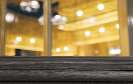 Selective Empty wooden table in front of abstract blurred festive light background with light spots...
