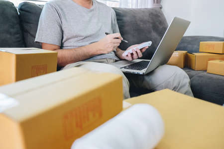 Small business parcel for shipment to client at home, Young entrepreneur SME freelance man working...