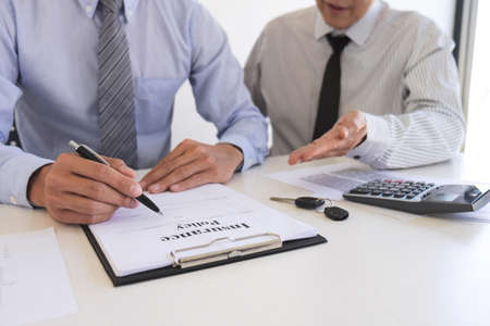 Real estate broker agent presenting and consult to customer to decision making sign insurance form...