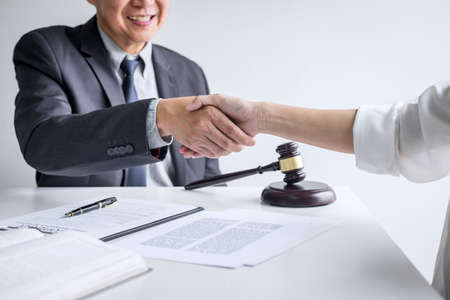 Good service cooperation of Consultation between a male lawyer and business woman customer, Handshake after good deal agreement, Law and Legal concept.の写真素材