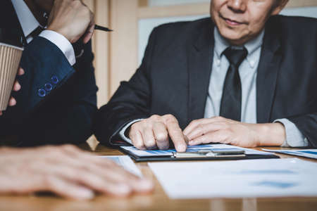 Co working conference, Business team colleagues discussing working analysis with financial data and marketing growth report graph in team, Business finances and accounting concept.の写真素材