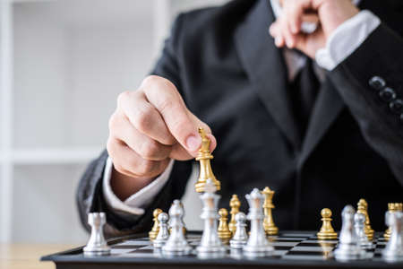 Hands of confident businessman playing chess game to development analysis new strategy plan, leader...