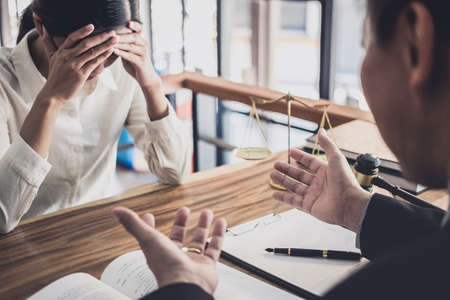 Consultation and conference of professional businesswoman and Male lawyers working and discussion having at law firm in office. Concepts of law, Judge gavel with scales of justice.の写真素材