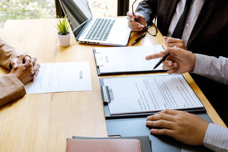 Two selection committee manager reading a resume during a job interview, Employer interviewing to...