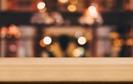 Selective Empty wooden table in front of abstract blurred festive light background with light spots...