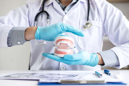 Doctor dentist protection dental tooth model on workplace with x-ray film.の写真素材