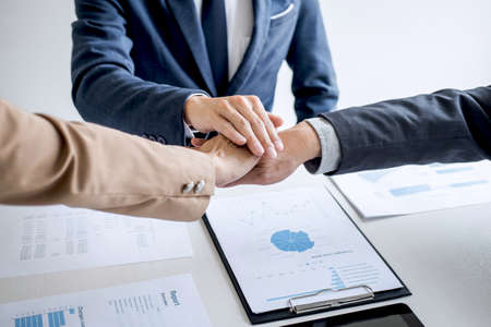 Image of business people joining and putting hands together during their meeting, connection and collaboration concept, Teamwork process of partner and best relationship.の写真素材