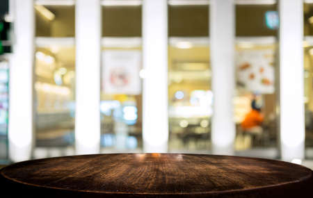 Selective Empty wooden table in front of abstract blurred festive light background with light spots...