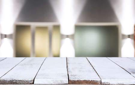 Selective Empty wooden table in front of abstract blurred festive light background with light spots and bokeh for product montage display of product.の写真素材