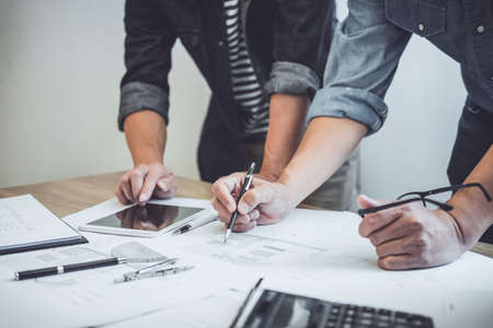 Construction and structure concept of Engineer or architect meeting for project working with partner and engineering tools on model building and blueprint in working site, contract for both companies.の写真素材