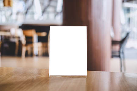 Mock up acrylic frame posters pattern template forms background, blank menu frame on table in coffee shop stand for your text of display your product.の写真素材