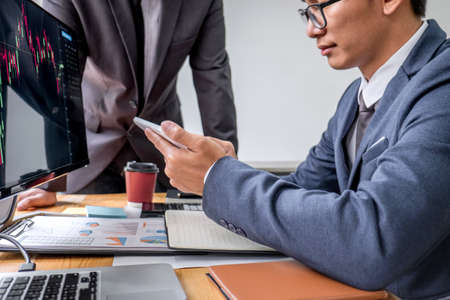 Business team partner working with computer, laptop, discussion and analyzing graph stock market trading with stock chart data planning, financial and investment concept.の写真素材