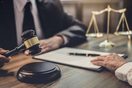 Businesswoman and Male lawyer or judge consult having team meeting with client, Law and Legal services concept.の写真素材